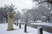 Snow scene and New Forest National Park sign at Moyles Court near Ringwood Hampshire England