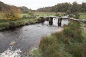 Ancient clapper bridge over the East Dart river at Postbridge Dartmoor National Park Devon