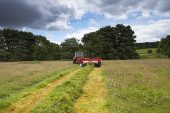 Farmer cutting the hay Askrigg Bottoms Meadow Askrigg Wensleydale Yorkshire Dales National Park Yorkshire England UK July 2016