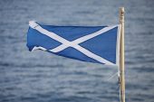 Saltire the Scottish flag flying from the stern of the Caledonian MacBrayne ferry Finlaggan Scotland UK