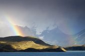 Rainbow over a hillside beside Lake Pehoe with mountains beyond Torres del Paine National Park The Andes Patagonia Chile South America December 2016