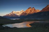 Small lake with Lake Nordenskjold and the Blue Massif beyond at sunrise Torres del Paine National Park The Andes Patagonia Chile South America December 2016