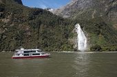 Boat on Milford Sound with Bowen Falls beyond Fiordland National Park South Island New Zealand
