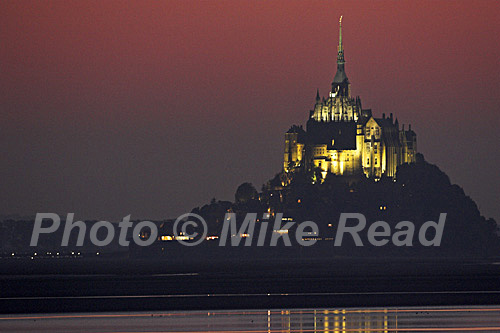Sunset sky over a floodlit Mont-St-Michel, Normandy, France
